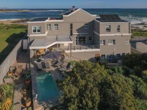 an aerial view of a house with the ocean in the background at Absolute Ocean Boutique Guesthouse in Hermanus