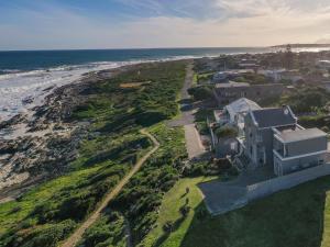 an aerial view of a house next to the ocean at Absolute Ocean Boutique Guesthouse in Hermanus +7 photos