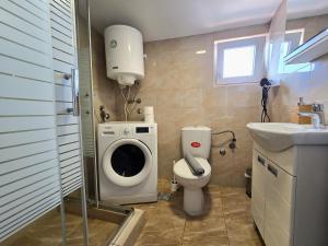 a small bathroom with a toilet and a sink at Apartman Gloria Sajam - Panorama in Belgrade +6 photos