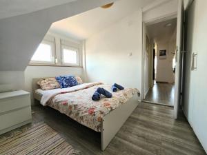 a bedroom with a bed with shoes on it at Apartman Gloria Sajam - Panorama in Belgrade