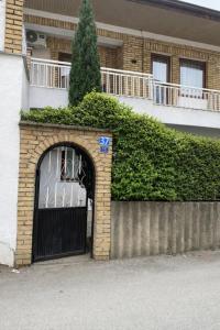 a building with a black garage door with graffiti on it at Serana Stays Modern Rooms with Private Bathroom, Free WiFi & Parking, Central Pejë in Peje