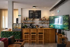a bar in a restaurant with a waterfall on the wall at Kallithea INN in Platres +44 photos