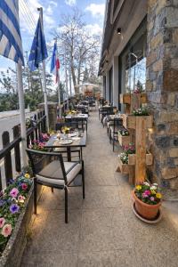 a row of tables and chairs outside of a restaurant at Kallithea INN in Platres