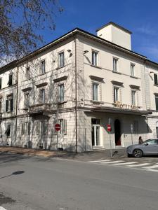 a large white building on the side of a street at Hotel Il Sole in Empoli