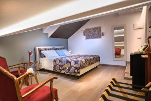 a bedroom with a king sized bed and a chair at Maison Bra 10 in Verona