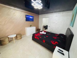 a bedroom with a bed and a tv on a wall at BGD Residence in Galaţi