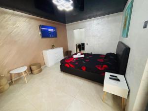 a bedroom with a bed and a tv on a wall at BGD Residence in Galaţi +2 photos