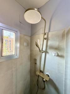 a bathroom with a shower with a shower head at James Hotel & Apartments in Juba +26 photos