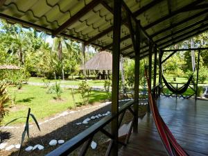 a porch with a view of a garden at Sabalo Lodge Tours and Cabins in Sierpe