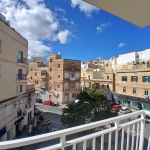 a view of a city from a balcony at The Black Onyx in Il-Gżira