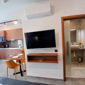 a living room with a television on a wall at The Black Onyx in Il-Gżira +208 photos