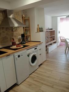 a kitchen with a washing machine in a kitchen at Ca la Carme in Villalba dels Arcs +11 photos