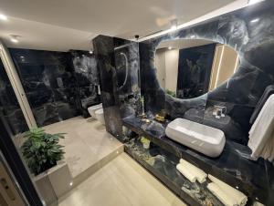 a bathroom with a sink and a mirror at Twentyseven Luxury Suite in Catania