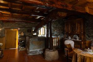 a living room with a fireplace in a house at Casa do Lagar in Vale do Porco +45 photos