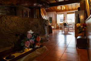a living room with a tile floor and a fireplace at Casa do Lagar in Vale do Porco