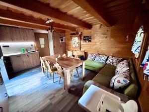 a living room with a table and a couch at Chatka pod orechom in Terchová