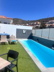 a swimming pool on the roof of a house at ViLLA DANEIRA LUX in Mogán