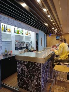 two people sitting at a counter in a kitchen at ibis Aurillac in Aurillac