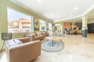 a living room with couches and a table at BLUESEA Miramar Fuengirola in Fuengirola