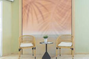 two chairs and a table in front of a large painting at BLUESEA Miramar Fuengirola in Fuengirola