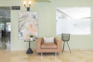 a chair in a room with a picture on the wall at BLUESEA Miramar Fuengirola in Fuengirola