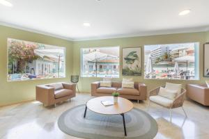a living room with couches and chairs and a table at BLUESEA Miramar Fuengirola in Fuengirola