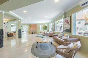 a living room with a couch and a table at BLUESEA Miramar Fuengirola in Fuengirola +57 photos