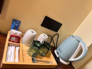 a table with a blender and other appliances on it at Novara Haven Airport Transit Hotel in Katunayaka