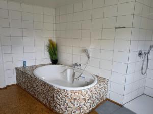 a bath tub in a bathroom with a shower at Haus-Dorfidyll in Spangenberg +48 photos