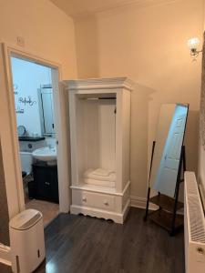 a bathroom with a vanity with a mirror and a sink at The Queens Hotel Harlech in Harlech