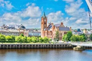a city with a clock tower and a bridge over a river at 1 Bed Flat - Sleeps 2 - Parking - Garden in Derry Londonderry