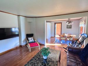 a living room with a couch and a table at Hus Stora Hultet in Hultsfred