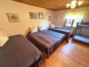 a bedroom with two beds and a window at Hus Stora Hultet in Hultsfred