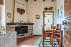 a living room with a fireplace and a table and chairs at Agriturismo i Due Casini in Riano +68 photos