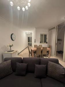 a living room with a couch and a table at Tommy's Retreat Xewkija in Xewkija