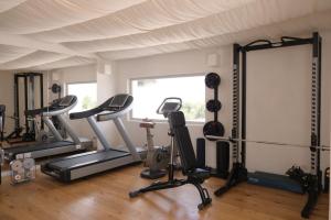 a gym with treadmills and exercise equipment in a room at Masseria Borgo Ritella in Fasano