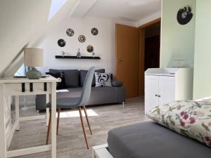 a living room with a couch and a table at Ferienwohnung Maria mit Elbblick in Coswig +15 photos