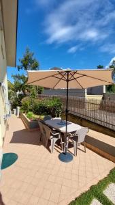 a table and chairs under an umbrella on a patio at La Pineta, 26 - 5 in Casarza Ligure