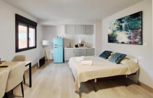 a bedroom with a bed and a blue refrigerator at Premium Luxury Muralla de Lugo 2.3-A in Lugo