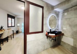 a bathroom with a sink and a mirror on a wall at Premium Luxury Muralla de Lugo 2.3-A in Lugo