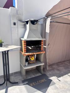 an outdoor oven is set up in a tent at ViLLA DANEIRA LUX in Mogán