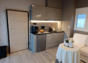 a kitchen with a table in a room with a table sidx sidx at VueSurMer Amarynthos in Amarynthos +17 photos