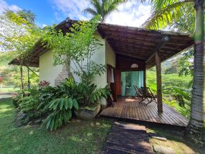 a porch of a house with a wooden deck at Villa Sana Maritacas in Sana