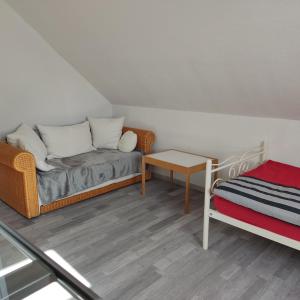 a living room with a couch and a table at Haus Amsel am Heeder See in Heede