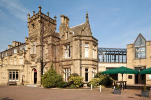 an old stone building with a table in front of it at Mercure Bradford, Bankfield Hotel in Bradford