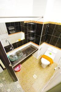 a bathroom with a toilet and a sink at AC Sport Village in Bangkok