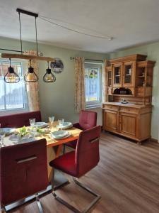 a kitchen and dining room with a table and chairs at Dahoam am Silberberg in Bodenmais