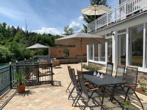 a patio with a table and chairs with umbrellas at Sokograd Entire House in Šipovo