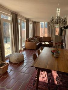 a living room with a table and a couch at Sokograd Entire House in Šipovo +30 photos