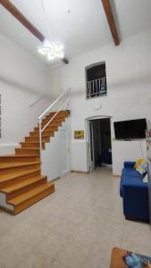 a living room with a staircase and a blue couch at Room34Trani in Trani